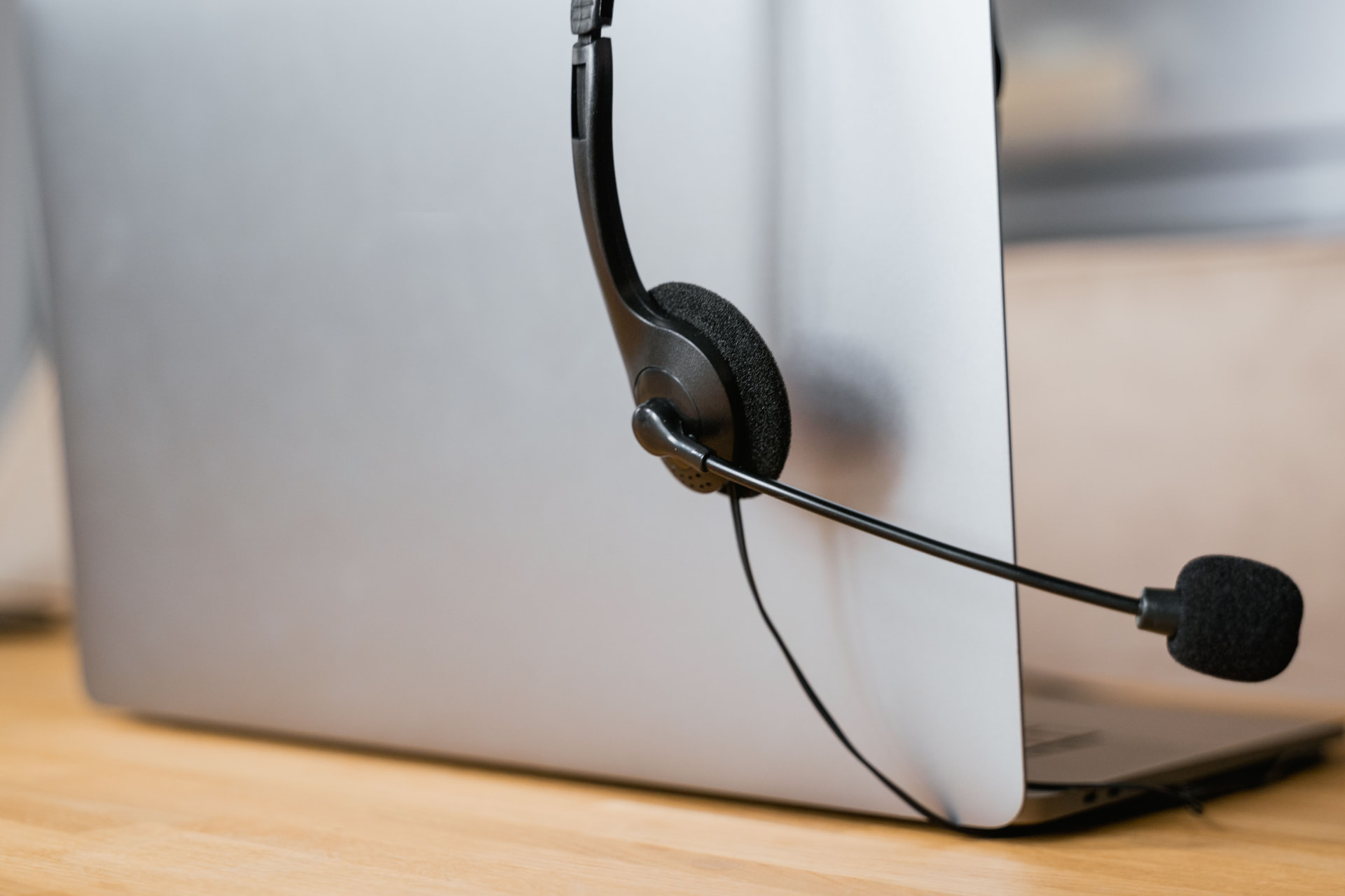 Headset resting on a laptop ready for a sales call